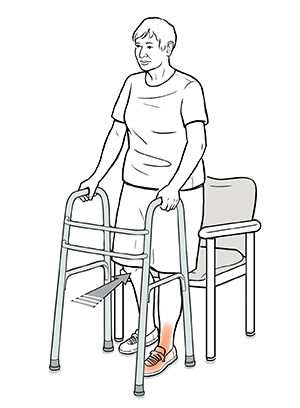 Person with walker backing up into chair, one hand on walker and one on arm of chair, until chair is touching back of her legs.